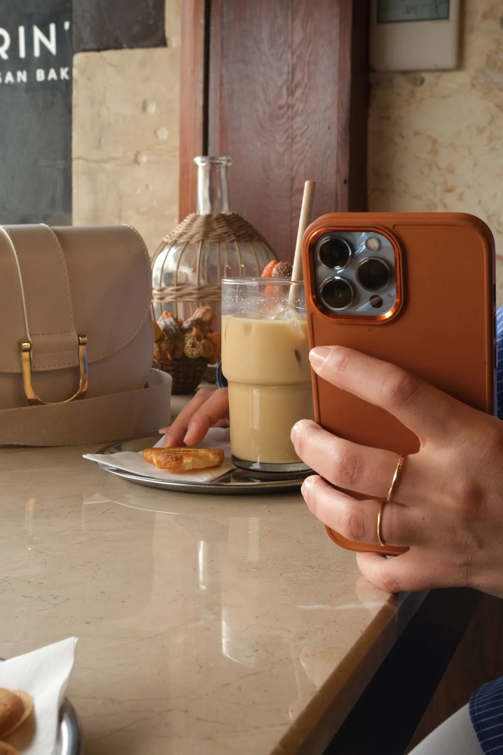 Customer photographing a latte on a phone